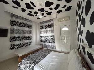 a bedroom with a black and white patterned wall at Basilio's Studios in Leptokarya