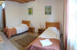 a room with two beds and two night stands at Pensiunea Ara in Alba Iulia