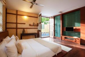 a bedroom with a bed and a large window at StayVista at The Yercaud Bungalow with Pvt Pool in Yercaud +21 photos