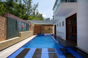 a swimming pool in the backyard of a house at StayVista at The Yercaud Bungalow with Pvt Pool in Yercaud