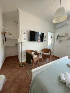 um quarto com uma cama e uma televisão na parede em Pizzo Central House em Pizzo