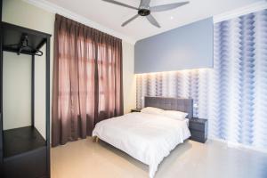 a bedroom with a white bed and a ceiling fan at The Duyong Dream in Malacca