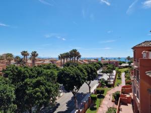 a city street with palm trees and buildings at G&G Premium Los Alamos in Torremolinos