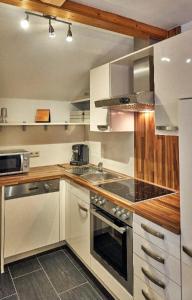 a kitchen with a sink and a stove top oven at Ferienwohnung Fritz in Bodenmais