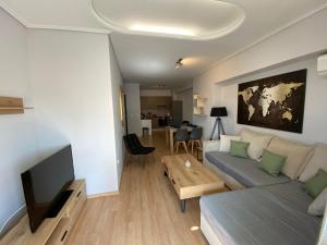 a living room with a couch and a table at Spetson Modern 56sqm apt in Piraeus in Piraeus