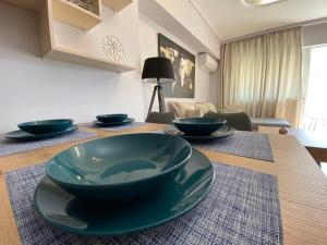 a dining room table with bowls on top of it at Spetson Modern 56sqm apt in Piraeus in Piraeus