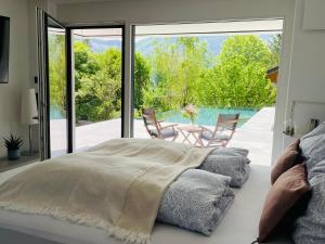 a bedroom with a bed and a view of a pool at place2be - exclusive apartment in Faistenau