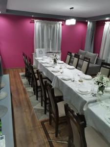 a dining room with a long table and chairs at Apartament u Wioli in Okleśna +47 photos