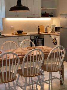 uma cozinha com uma mesa de madeira e 4 cadeiras em Villa Regina em Gaios