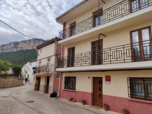 a building with balconies on the side of a street at CASA GLORIA in Ganuza