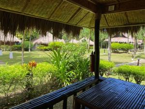 a blue bench on the porch of a resort at Hijo Resorts Davao in Tagum