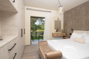 a bedroom with a bed and a sliding glass door at Aerinos private villa in Lefkada Town