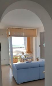 a living room with a blue couch and a table at La Savina Ses Platgetes in La Savina