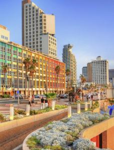 a city with tall buildings and a street with at Dizengoff square garden in Tel Aviv