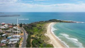 an aerial view of a beach and the ocean at La Ronde Three - Unit 3 - Oceanstays in Yamba