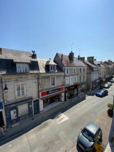 a street with buildings and a car parked on the street at Chambre & salle de bain privée - LV 33 in Argenton-sur-Creuse