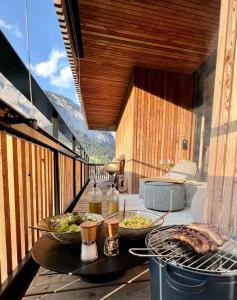 a balcony with two bowls of food on a grill at the NEST flims in Flims