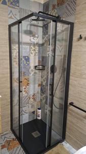a shower with a glass door in a bathroom at Resort il cigno in Peschiera del Garda