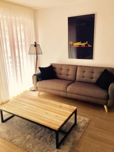 a living room with a couch and a coffee table at 2 BED APARTMENT IN BANSKO RESORT in Bansko