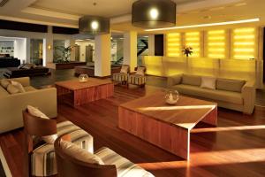 a living room with couches and tables at Belmar Spa & Beach Resort in Lagos