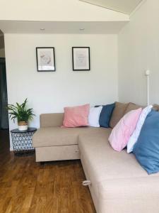 a living room with a couch with pillows on it at Tiny house 't Heidehoes in Usselo in Enschede