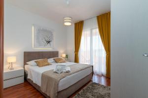 a bedroom with a bed and a large window at Villa Tonina in Trogir