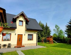 a house with a playground in the yard at Domek w Chochołowie in Chochołów