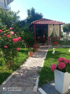a garden with a gazebo and flowers at Bellarias House in Nydri