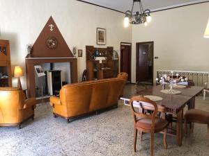 a living room with a table and chairs at Antica residenza La Rocca in Montefiascone