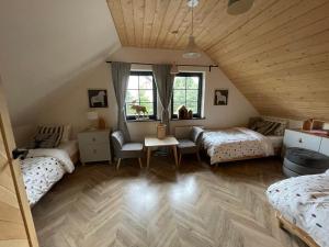 a attic bedroom with two beds and a table at Willa na szlaku in Stronie Śląskie