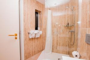 a bathroom with a shower with a glass door at Giorgio Boutique Hotel in Sliema