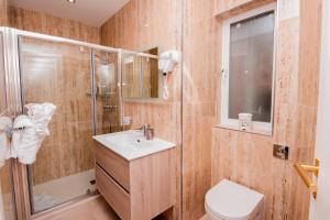 a bathroom with a sink and a shower and a toilet at Giorgio Boutique Hotel in Sliema