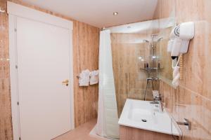 a bathroom with a sink and a shower at Giorgio Boutique Hotel in Sliema
