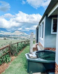 a hot tub on the side of a house at Courchevel Cottages in Franschhoek