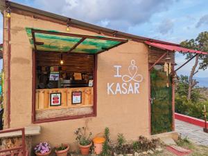 a restaurant with a sign on the side of a building at Traveller Hive Kasar Devi in Almora