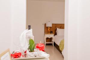 a bedroom with a bed and a table with a night stand at Giorgio Boutique Hotel in Sliema
