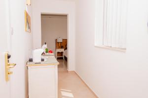 a white kitchen with a counter and a window at Giorgio Boutique Hotel in Sliema