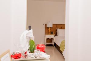 a bedroom with a bed and a table with a candle at Giorgio Boutique Hotel in Sliema
