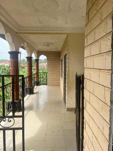 an empty corridor of a building with a balcony at A&G Guest House in Kumba