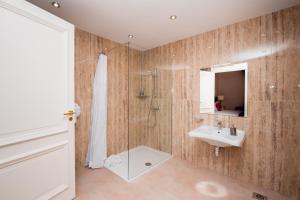 a bathroom with a shower and a sink and a mirror at Giorgio Boutique Hotel in Sliema