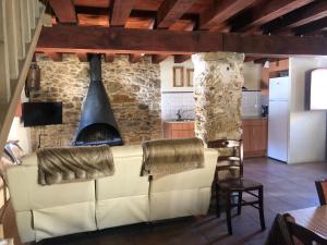 a living room with a couch and a fireplace at Cal Sastre in Pardines