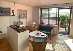 a living room with a couch and a table at Sønderstrand Bed & Breakfast Skagen in Skagen