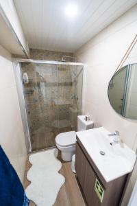a bathroom with a toilet and a sink and a shower at Casa Milita in São João da Pesqueira