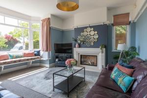 a living room with a couch and a fireplace at Winterstoke View-Family&Dog Friendly Beach Retreat in Ramsgate