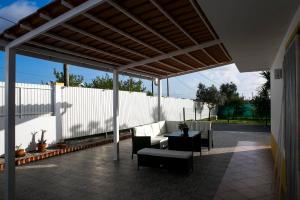 a patio with a table and chairs and a fence at Casa La Rosa with private pool in Loja de Vendas