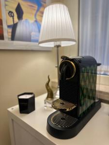 un ferro nero seduto su un tavolo accanto a una lampada di B&B Scarlatti 60 a Napoli