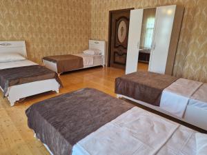 a room with three beds and a mirror at Mountain Resort House in Gabala +39 photos