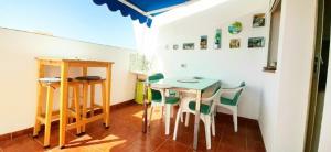a small room with a table and chairs at 5 minutes close by Playa del Inglés-1&2BR aptm with view & private terrace for 2 persons in El Tablero