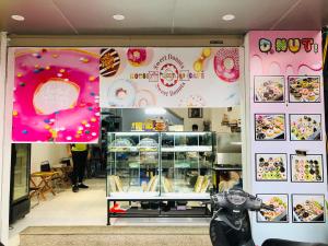 a doughnut shop with a pink donut in the window at Dnut's House in Hanoi