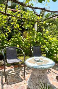 two chairs and a table and a table and chairs at Apartments Jovic in Mali Lošinj